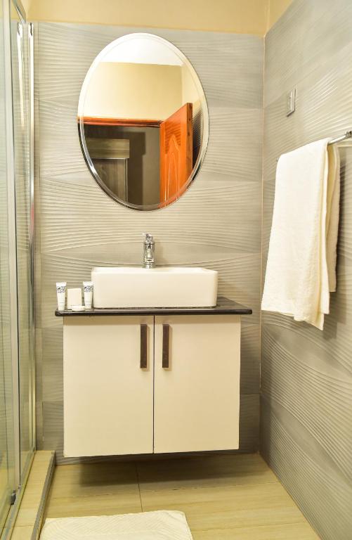 a bathroom with a sink and a mirror at El Sueno Homestay in Naivasha