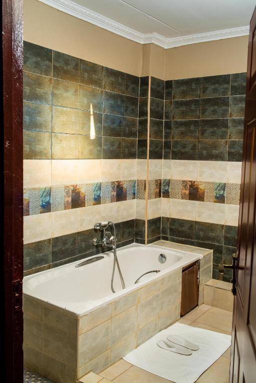a bathroom with a bath tub in a room at El Sueno Homestay in Naivasha
