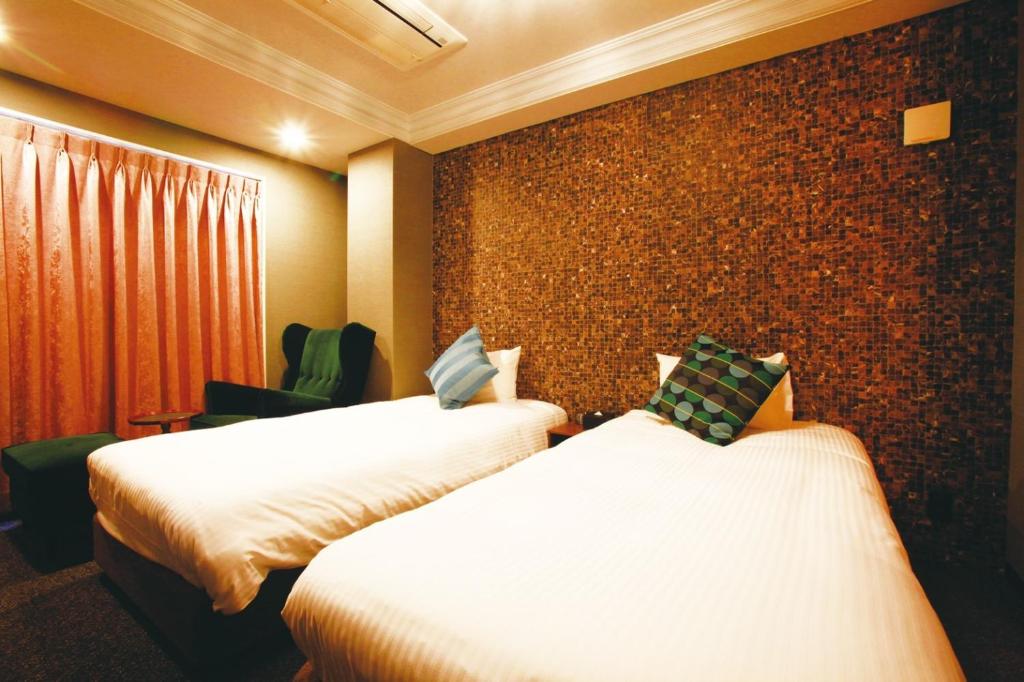 Postel nebo postele na pokoji v ubytování HOTEL STATE TENNOJI