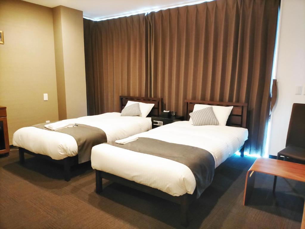 Postel nebo postele na pokoji v ubytování HOTEL STATE TENNOJI