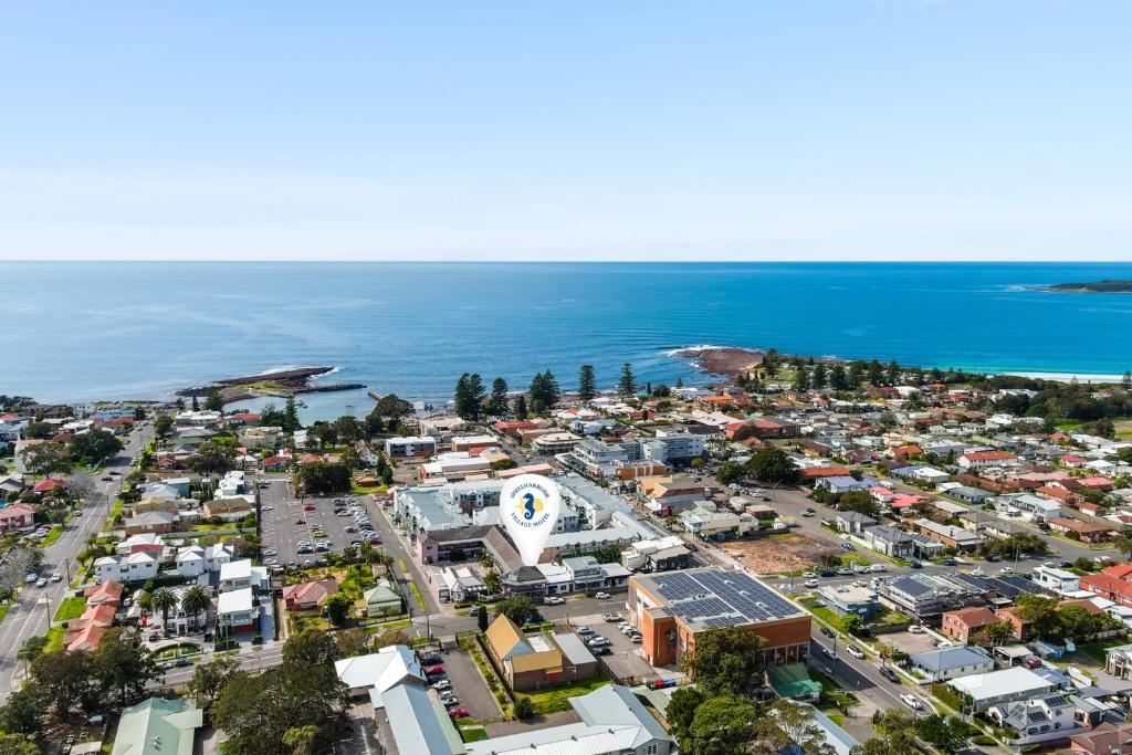 an aerial view of a city next to the ocean at Shellharbour Village Motel in Shellharbour
