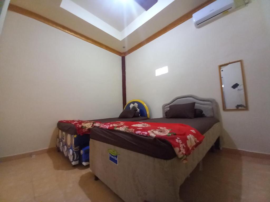 a bedroom with a bed in a room at OYO 90731 E-kreasi Home in Sekayu