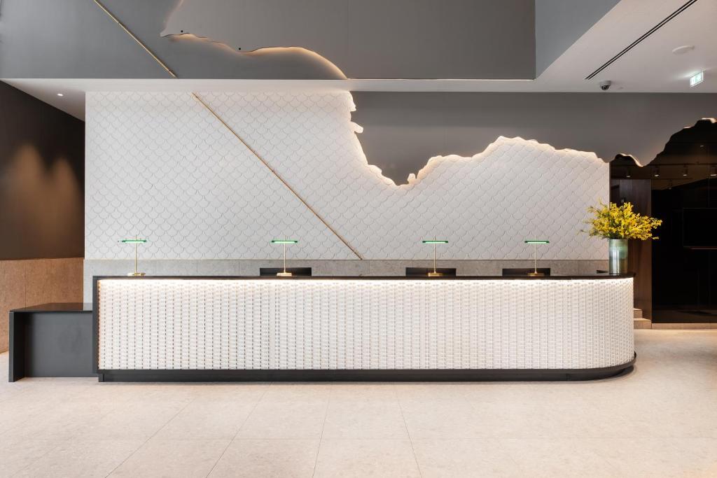 A large reception desk set against a dramatic illuminated wall.