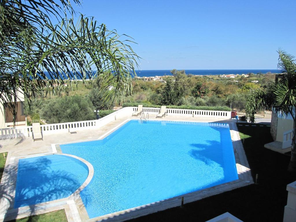 a swimming pool with a view of the ocean at Villa Pandora - Angela & Michali in Maleme