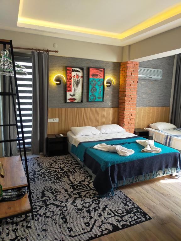 a hotel room with a bed and a ladder at Akdeniz apart hotel in Marmaris