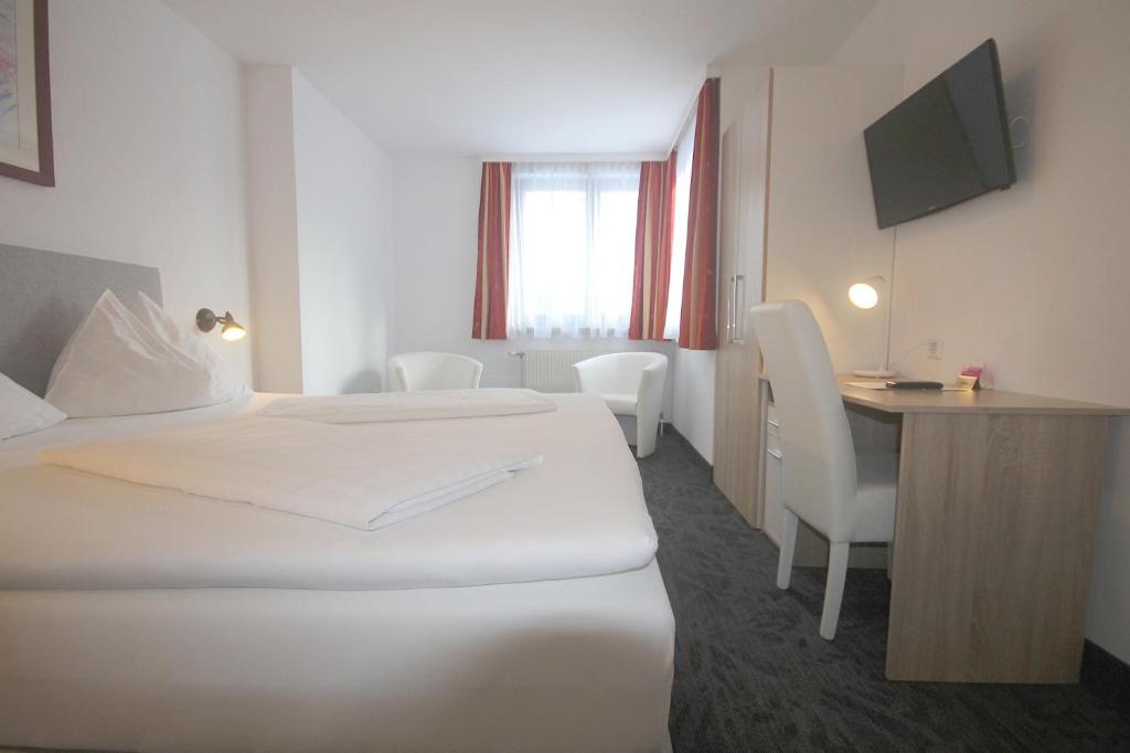 Postel nebo postele na pokoji v ubytování Hotel Altmann