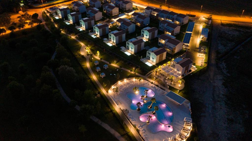 an overhead view of a resort at night with lights at Pareus Beach Resort in Caorle