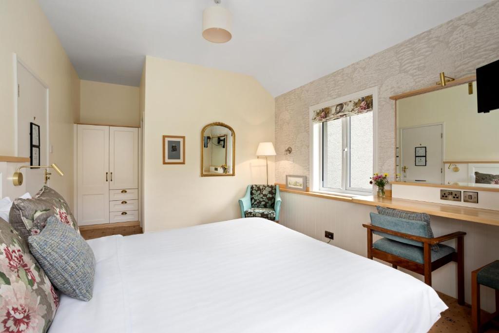 Voodi või voodid majutusasutuse Gougane Barra Hotel toas
