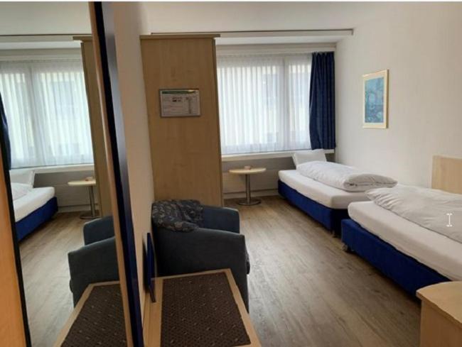 Postel nebo postele na pokoji v ubytování Hotel Blumenstein Self-Check In
