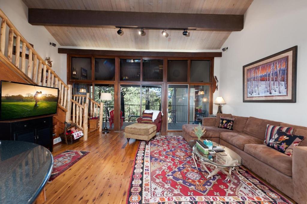 a living room with a couch and a tv at Tamarron PineCone 854 in Durango