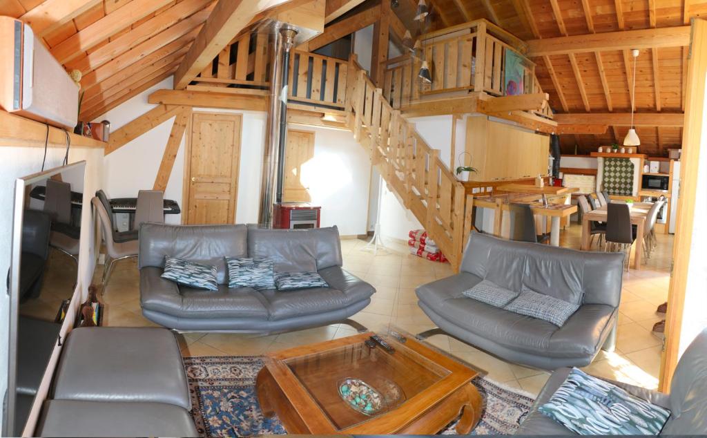 a living room with a couch and a table at Chalet Savoyard Balcon de Villy in Étaux