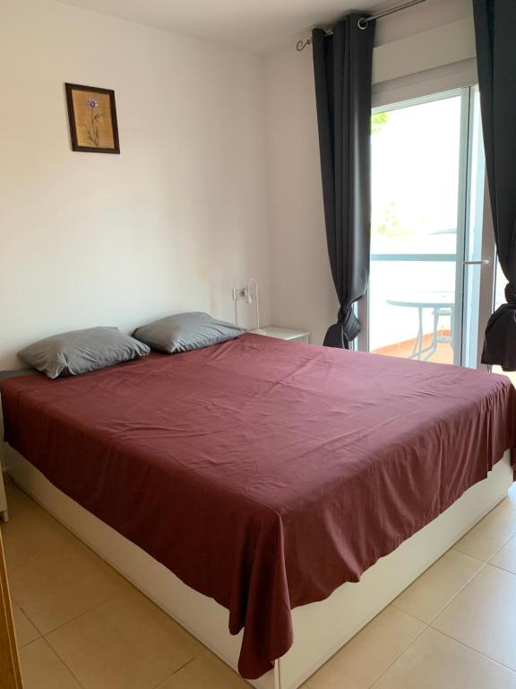 a bedroom with a large bed with a red blanket at Naranjo 7 - N565 - 2 bathrooms Apartment in Alhama de Murcia Golf Resort in Alhama de Murcia