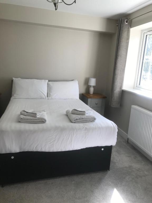 a bedroom with a bed with two towels on it at Cottage #1 in Aberystwyth