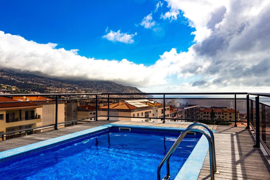 a swimming pool on the balcony of a building at Apartamento Batista by Horizon View Madeira in Funchal