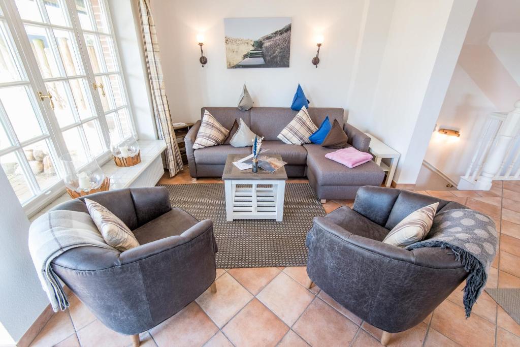 a living room with two chairs and a couch at Haus Osterweg 8 Whg 13 in Wenningstedt