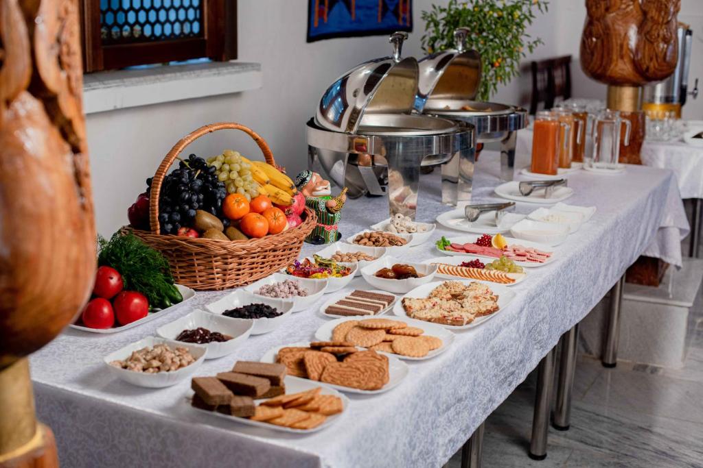 a table with a buffet of food on it at New Star Boutique hotel - madrasah Muhammad Mahram 1903 in UNESCO World Heritage Site in Khiva