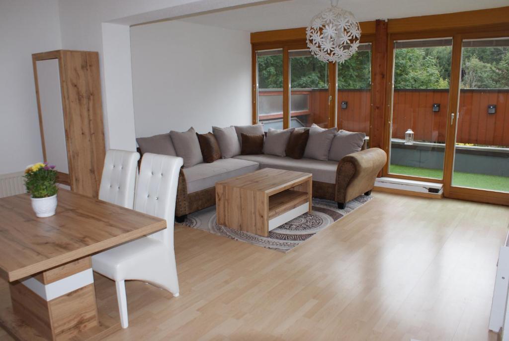 a living room with a couch and a table at Apartman BKK in Bad Kleinkirchheim