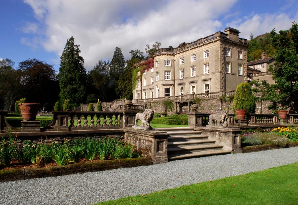 a building with a staircase in front of a garden at Rydal Hall in Rydal
