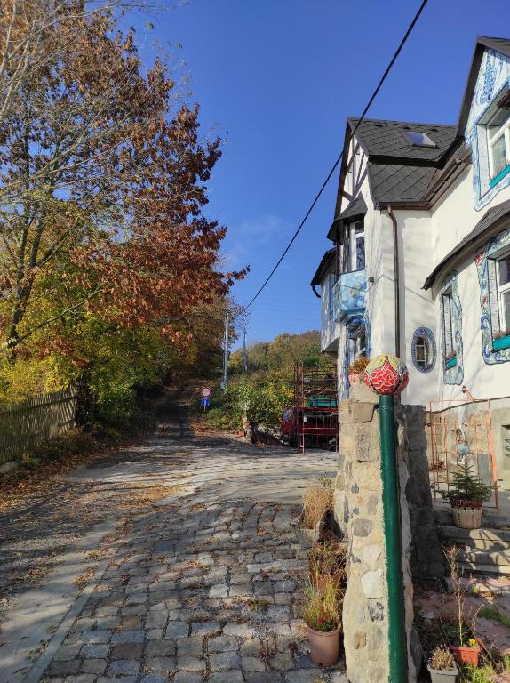 a cobblestone street in front of a house at art-house 4 Attic Apartment in Děčín