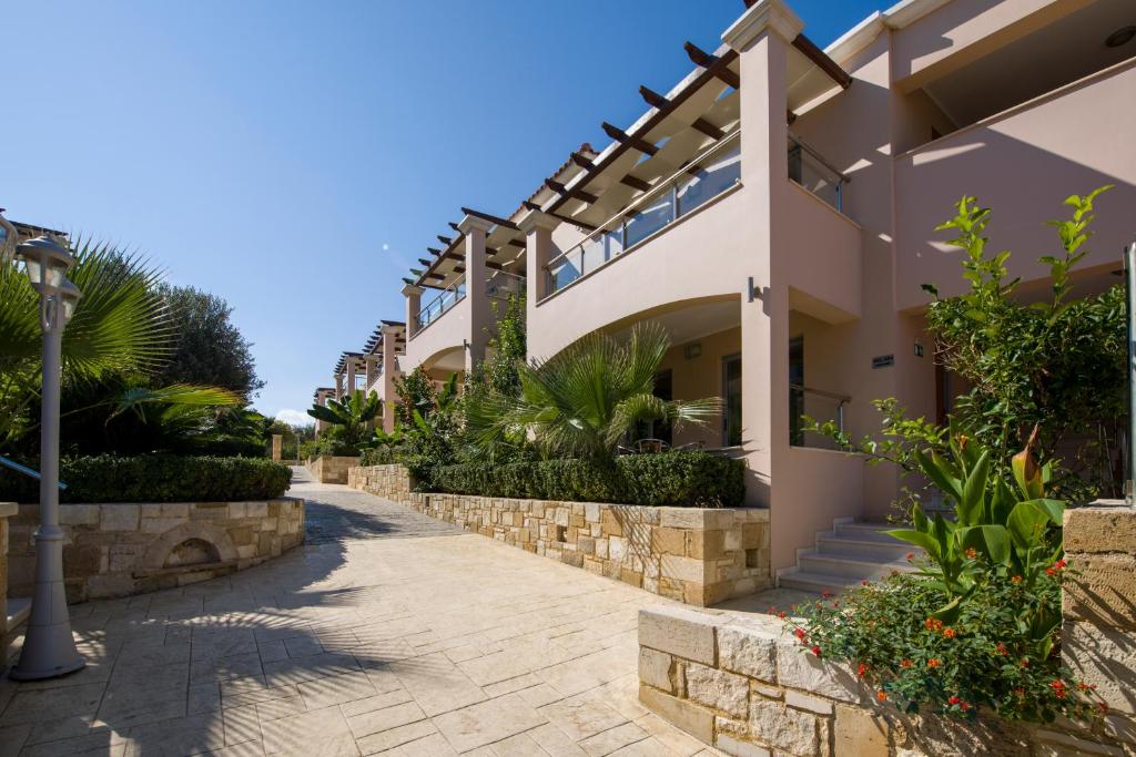 a house with a walkway in front of it at Isida Hotel Agia Marina in Agia Marina Nea Kydonias