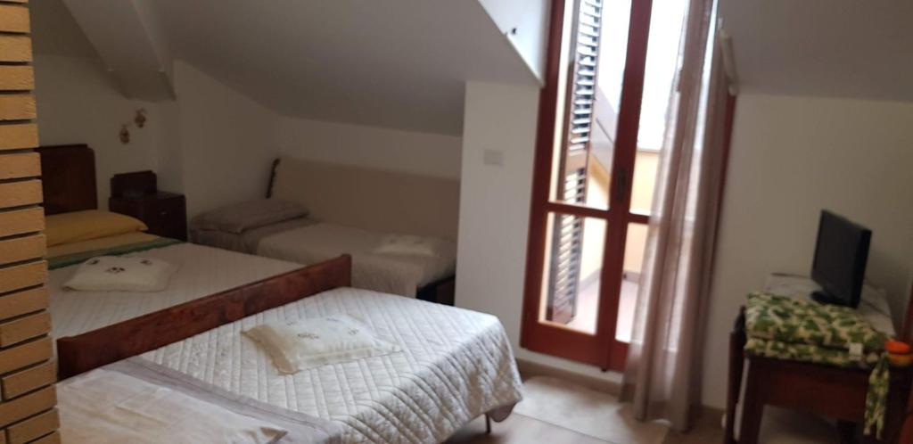 Posteľ alebo postele v izbe v ubytovaní Cà La Terrazza - DENTRO IL BORGO STORICO
