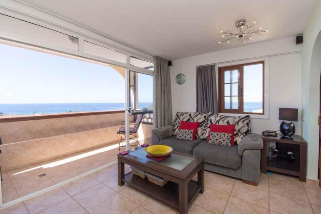 a living room with a couch and a table at Apartment in Palm-Mar - Insel Teneriffa 41647 in Palm-mar
