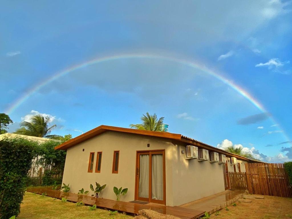 a rainbow over a small house with at Pousada Maresia in Fernando de Noronha