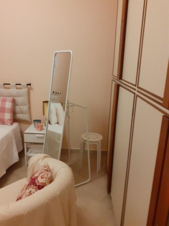 uma sala de estar com um espelho e uma cadeira em Damiani House em Marsala