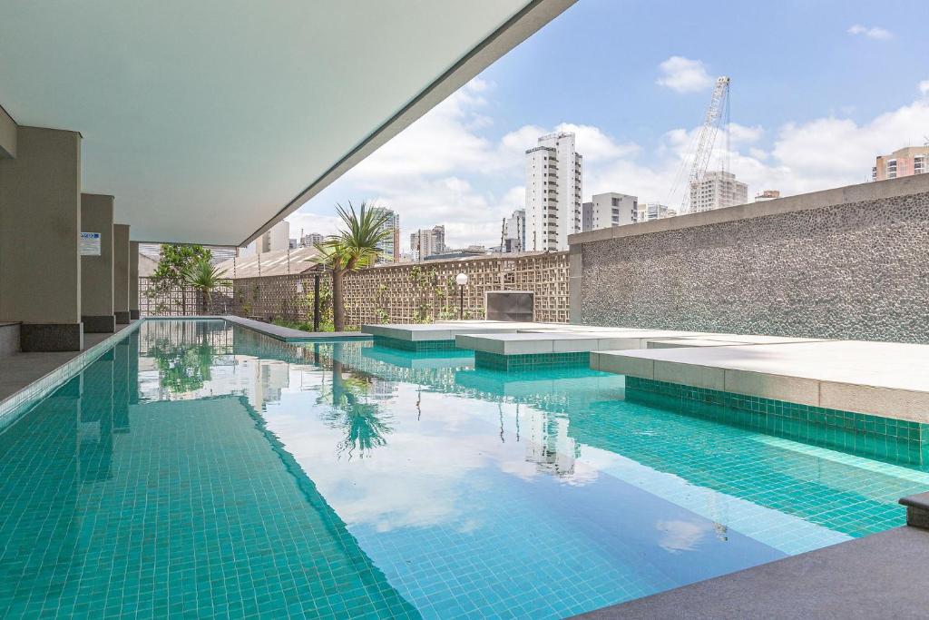 a swimming pool on the roof of a building at Vossa Bossa VN Turiassu in Sao Paulo