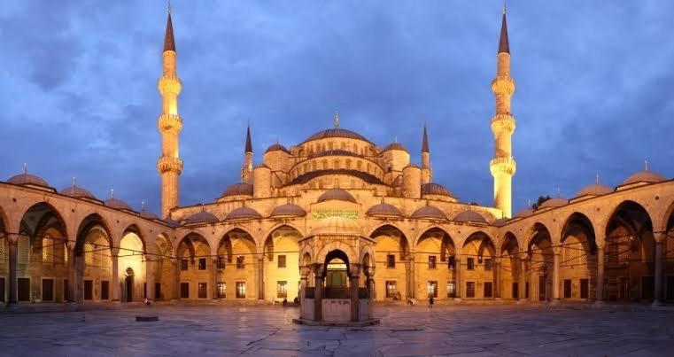 a large building with a mosque with two large towers at Hotel Otağ in Istanbul