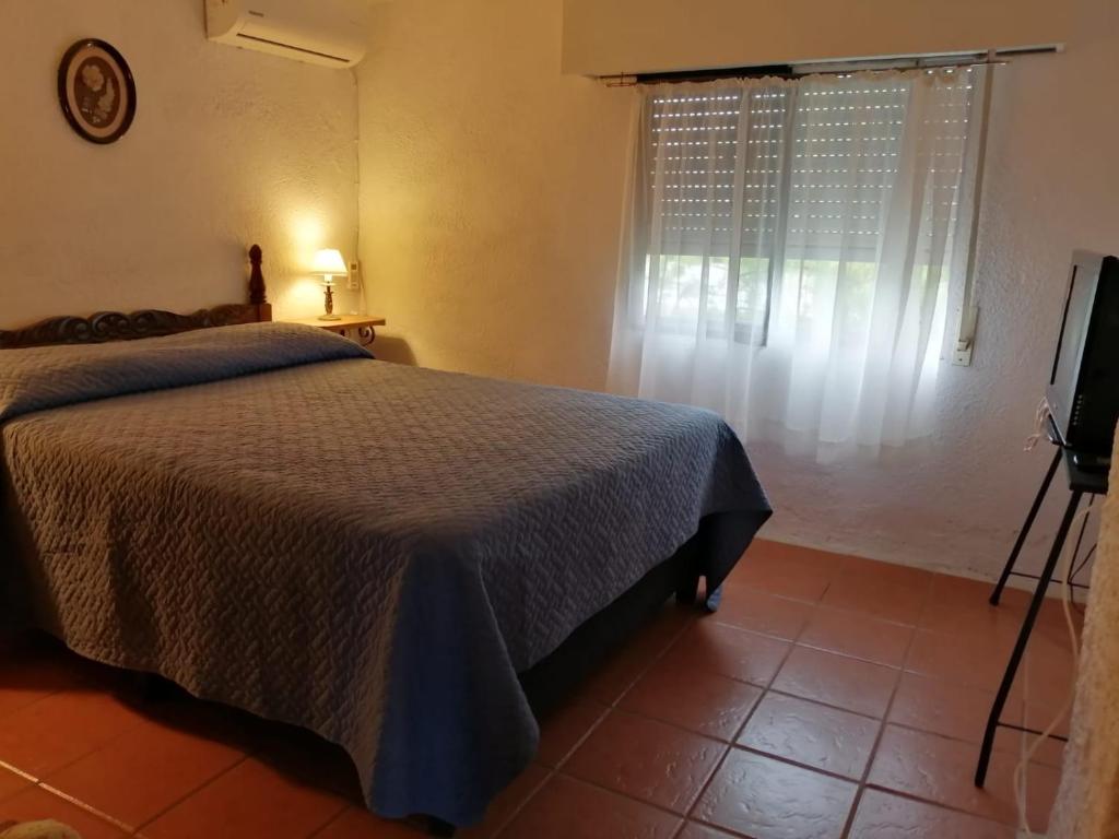 En eller flere senge i et værelse på Uruguay 1014 - Casa y Apartamento - Para 9 personas