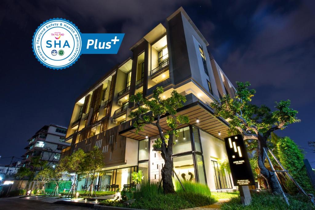 a building with the shka plus sign in front of it at Hyde Park Chiangmai in Chiang Mai