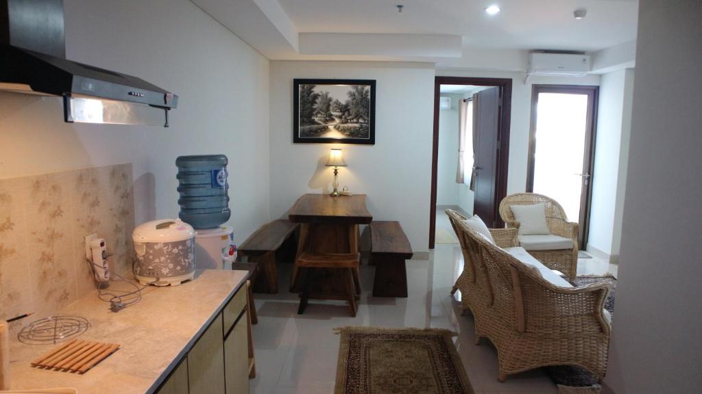 a kitchen with a counter and a table and chairs at Apartemen Tera Residence in Bandung