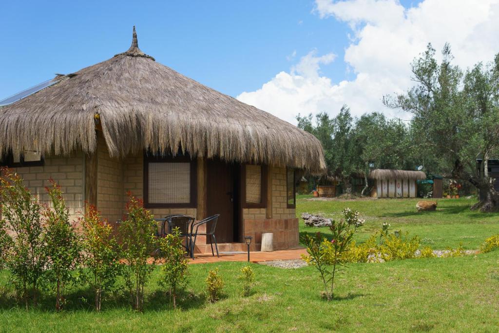 a small hut with a grass roof at Cabaña Campestre Sol Muisca RNT85322 in Villa de Leyva