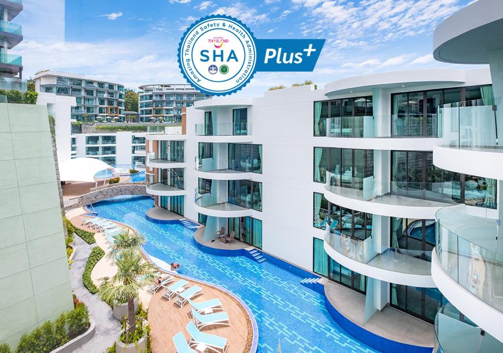 a large building with a clock on the front of it at Absolute Twin Sands Resort & Spa - SHA Extra Plus in Patong Beach