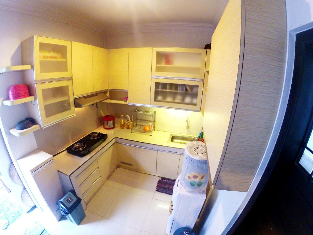 een kleine keuken met gele kasten en een koelkast bij Godean Living Homestay Jogja Family only in Ngabean