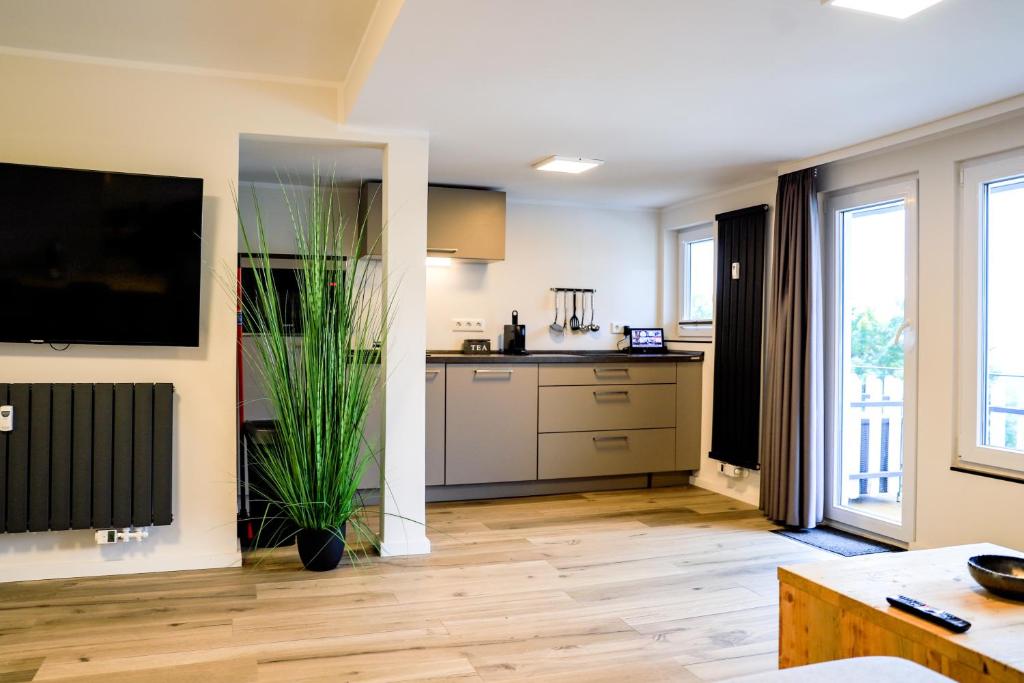a living room with a kitchen with a large window at Smart Resorts Haus Diamant Ferienwohnung 712 in Winterberg