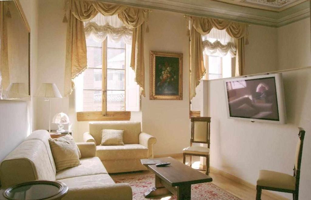 sala de estar con sofá y mesa en Tornabuoni La Petite Suite, en Florencia