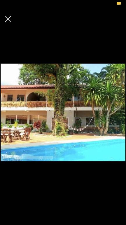 a resort with a swimming pool in front of a building at landmark karon in Karon Beach