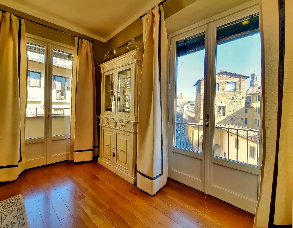 an empty room with a large window and a door at Hotel Balestri - WTB Hotels in Florence