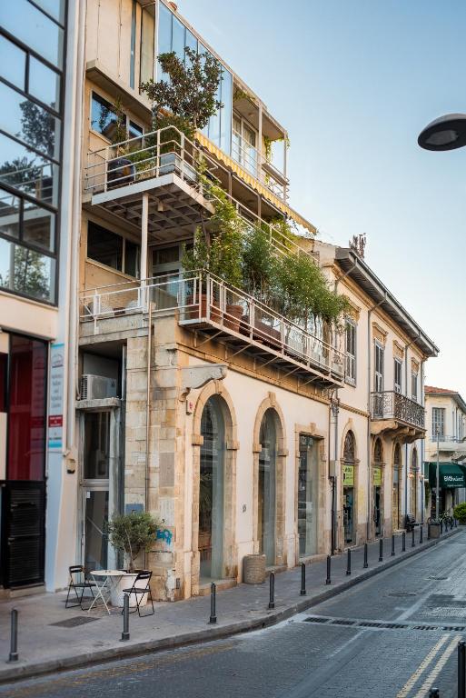 a building with plants on the balconies on a street at City Centre Studios in Limassol
