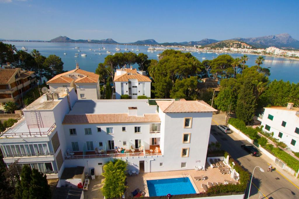 an aerial view of a large white house with a swimming pool at Hotel Villa Singala in Port de Pollensa