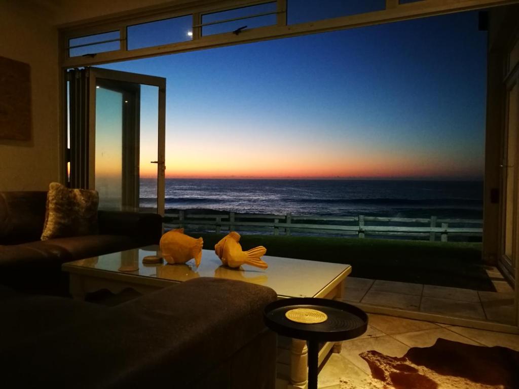 a living room with a view of the ocean at Sunshowers Ballito in Ballito