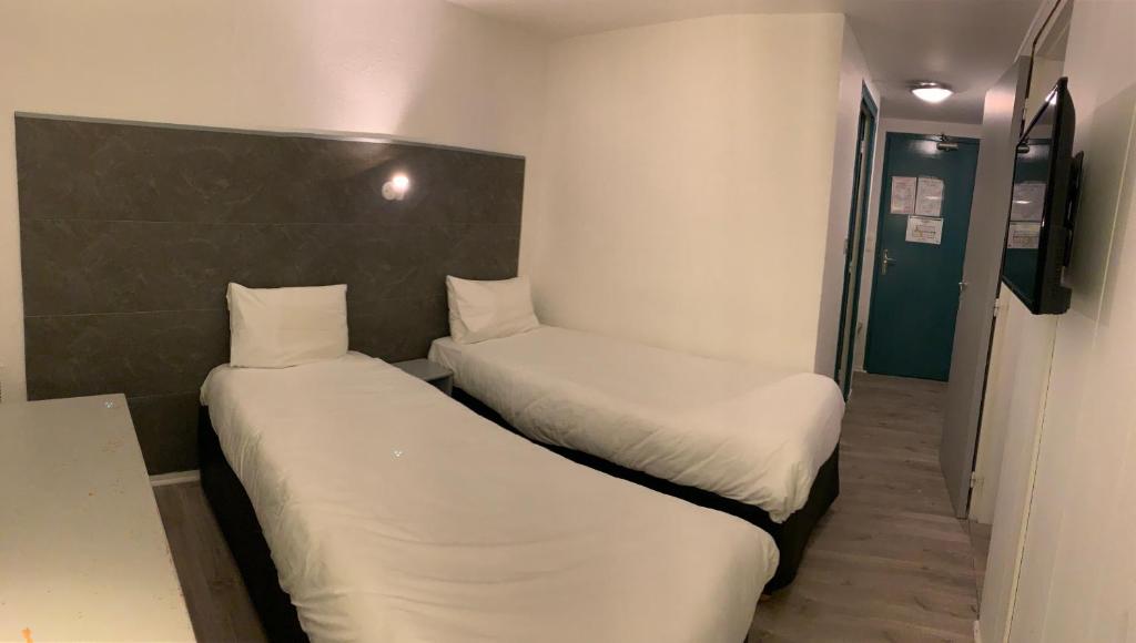 Postel nebo postele na pokoji v ubytování Hôtel Le Forestia