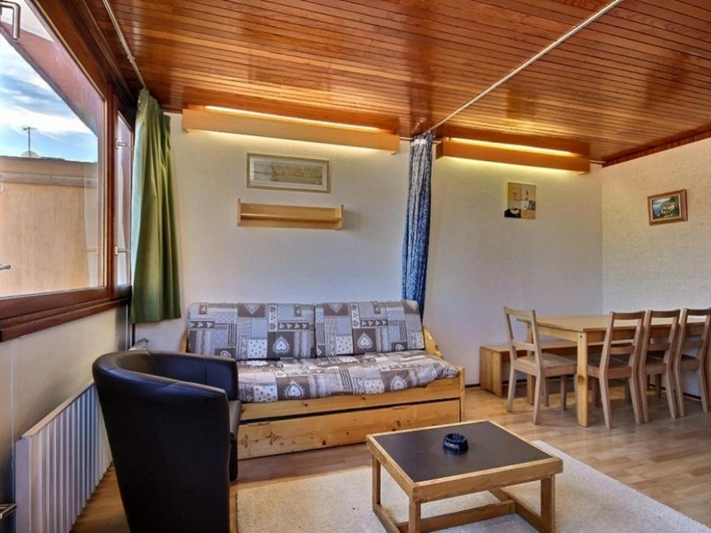 a living room with a bed and a table at Appartement La Plagne, 3 pièces, 8 personnes - FR-1-455-45 in La Plagne