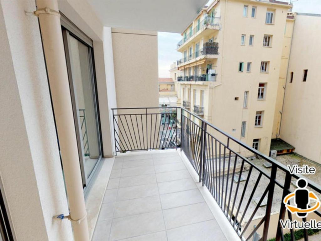 a balcony with a view of a building at Appartement Menton, 2 pièces, 4 personnes - FR-1-196-200 in Menton