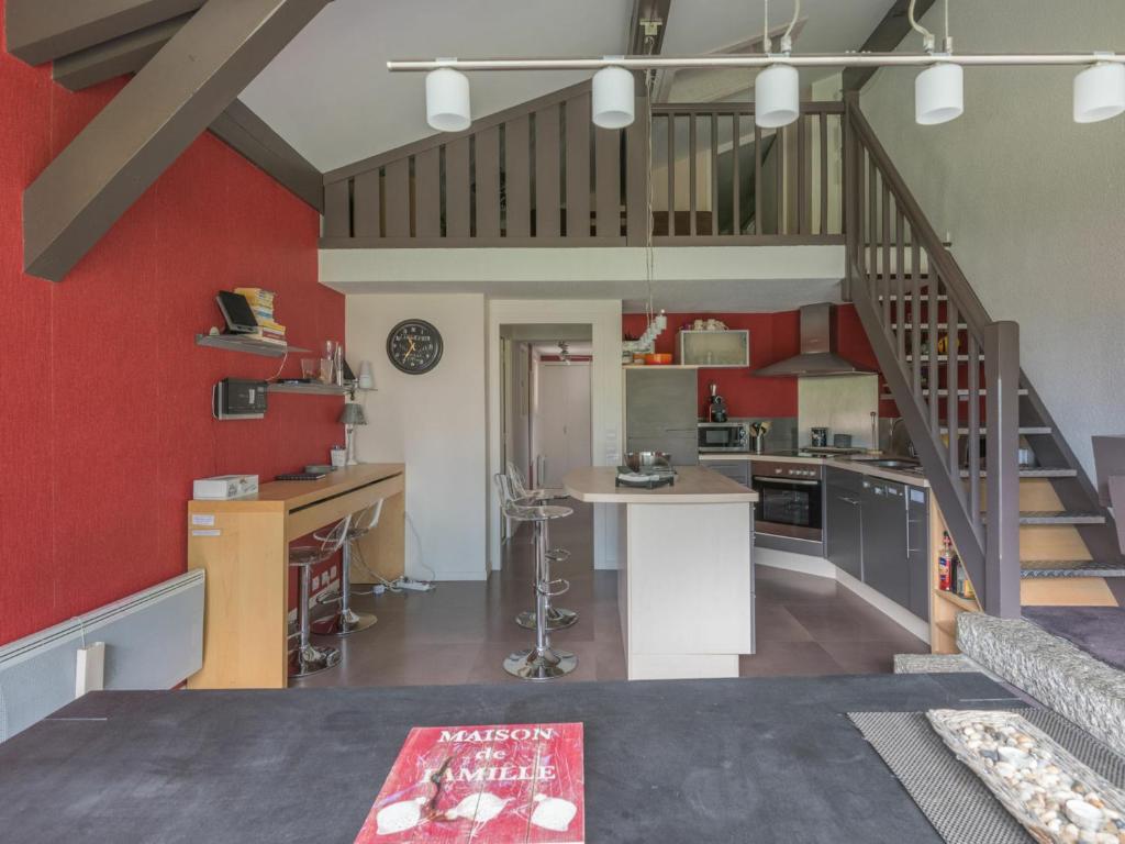 a kitchen with red walls and a spiral staircase at Appartement Chamonix-Mont-Blanc, 4 pièces, 6 personnes - FR-1-517-11 in Chamonix