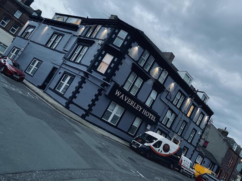 a blue building with a van parked in front of it at Waverley Hotel in Workington