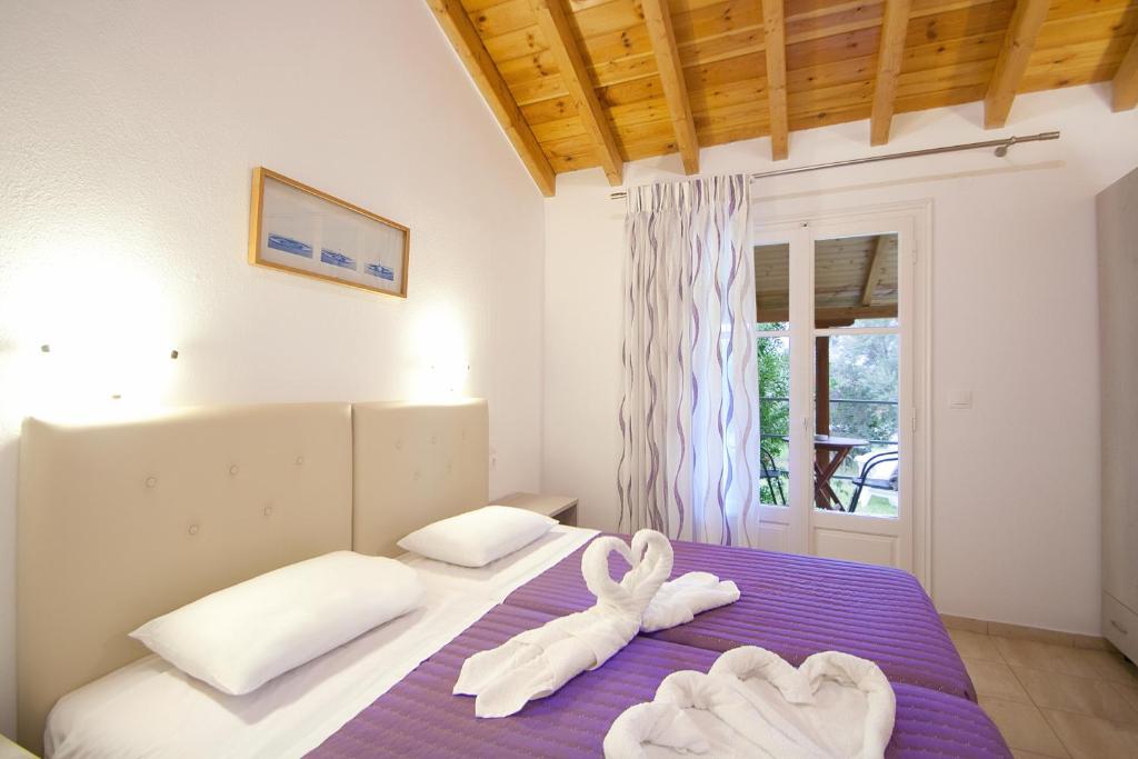 a bedroom with two towels on a bed at VOULA STUDIOS in Skiathos