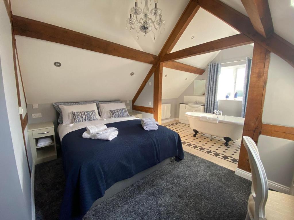 a bedroom with a bed and a dresser at Alexander Park Golf & Spa Resort B&B in Ledbury